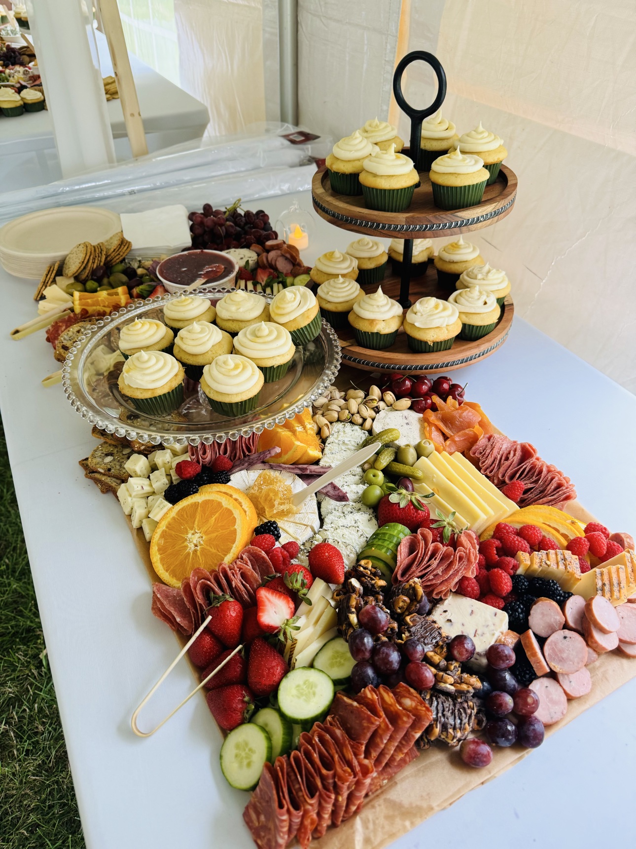 Grazing spread with a tiered stand of cupcakes