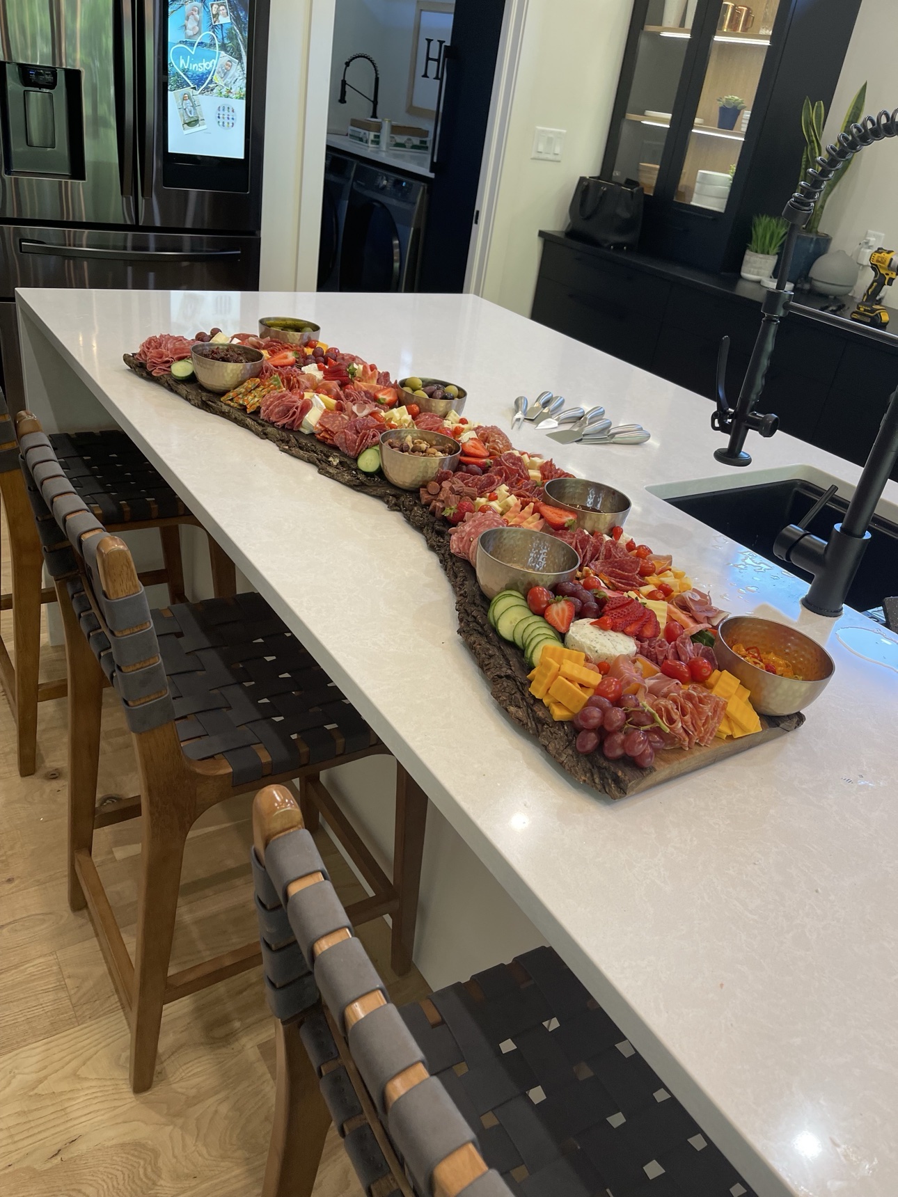 A long grazing board styled on a kitchen island